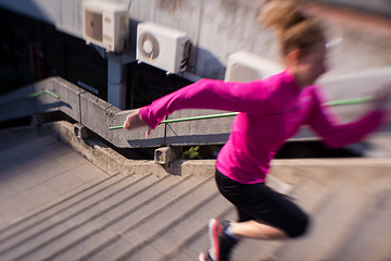 Image showing woman jogging on  steps