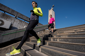 Image showing young  couple jogging on steps