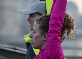 Image showing couple warming up before jogging