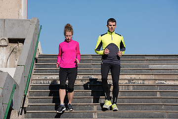 Image showing young  couple jogging on steps