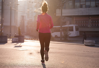 Image showing sporty woman jogging on morning