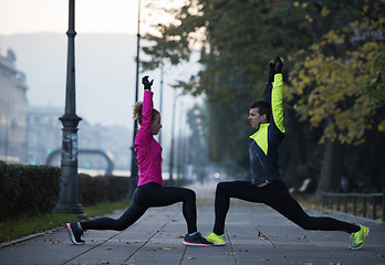 Image showing couple warming up before jogging