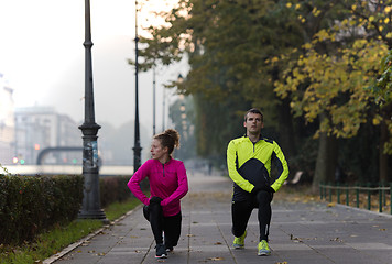 Image showing couple warming up before jogging