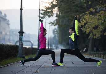 Image showing couple warming up before jogging