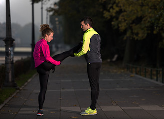 Image showing couple warming up before jogging