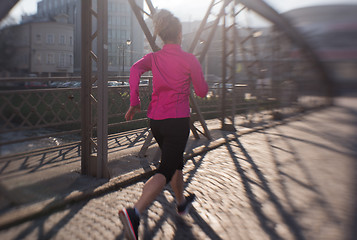 Image showing sporty woman jogging on morning