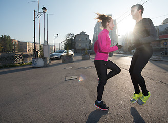 Image showing couple warming up before jogging