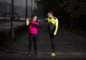 Image showing couple warming up before jogging