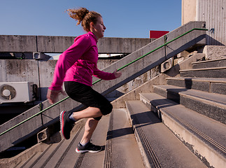 Image showing woman jogging on  steps