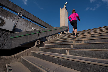 Image showing woman jogging on  steps