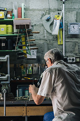 Image showing Senior mechanic working in garage