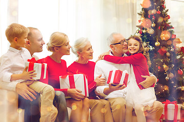 Image showing smiling family with gifts at home