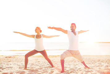 Image showing couple making yoga exercises outdoors