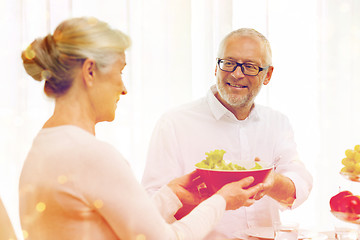 Image showing smiling senior couple having dinner at home