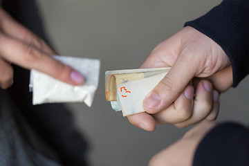 Image showing close up of addict buying dose from drug dealer