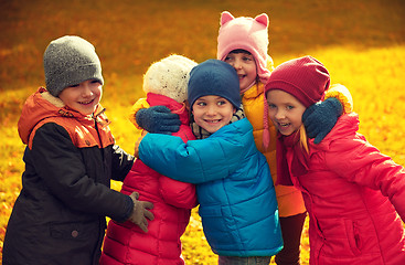 Image showing group of happy children hugging in autumn park