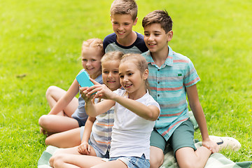 Image showing happy kids or friends taking selfie in summer park