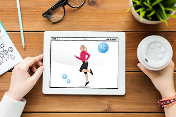 Image showing close up of woman with fitness app on tablet pc