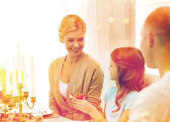 Image showing smiling family having holiday dinner at home