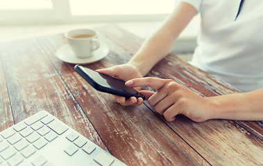 Image showing close up of hands with smart phone at office table