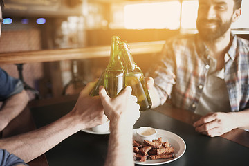 Image showing happy male friends drinking beer at bar or pub