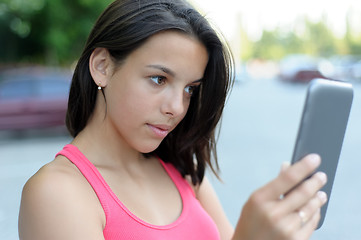Image showing Girl using tablet PC outdoor