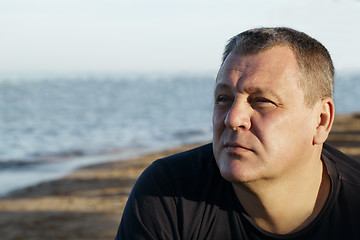 Image showing Handsome middle-aged man thinking at the beach