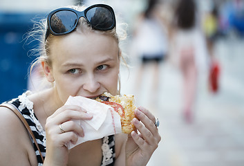 Image showing Young woman eating