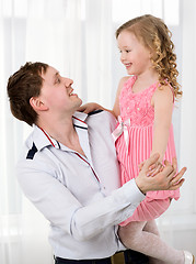 Image showing Father holding daughter and they dancing