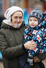 Image showing Woman holding her small son