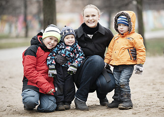 Image showing Happy mother with her three young children