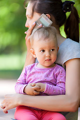 Image showing Baby girl in mothers arms