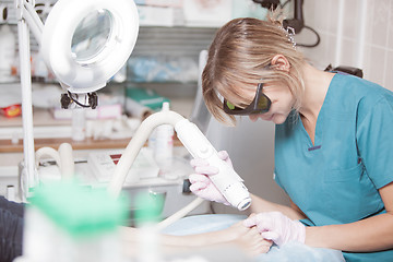 Image showing Foot treatment with a laser in clinic