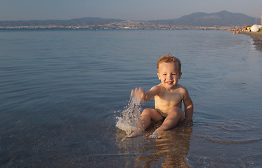 Image showing Cute little boy splashing in the sea