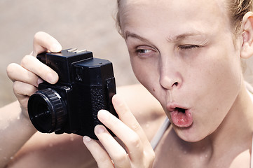 Image showing Woman photographer pulling a comical face