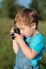 Image showing Little child taking pictures outdoor