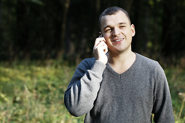 Image showing Man laughing as he chats on his mobile