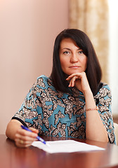 Image showing Attractive middle-aged woman working at home