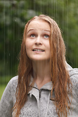 Image showing Girl enjoying rain in the park.