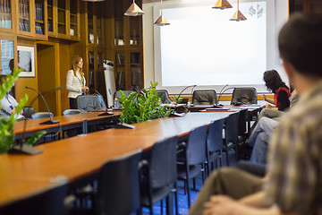 Image showing Student presenting his study work in front of whiteboard.