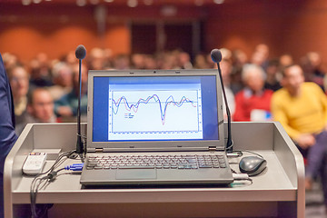 Image showing Computer and microphone on rostrum at business event.