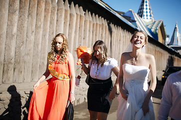 Image showing Bride and her bridesmaid walking with friends