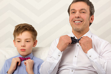 Image showing Father and son adjusting bowties