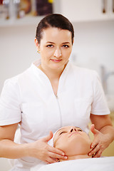 Image showing Facial treatment with massage therapist during seance at beauty spa