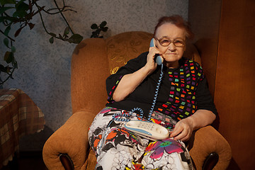 Image showing Elderly woman talking on the home phone