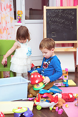 Image showing Children playing with toys at home