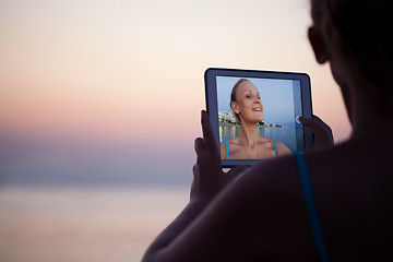 Image showing Woman making selfie on resort using pad