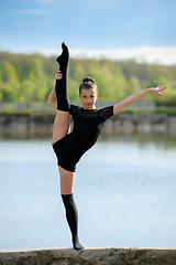 Image showing Rhythmic gymnast doing vertical leg-split