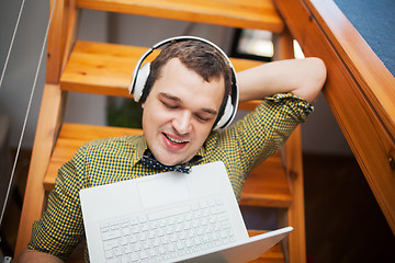 Image showing Man entertaining with laptop and music at home 