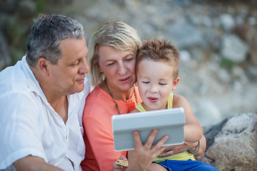 Image showing Grandparents and grandson with tablet PC outdoor